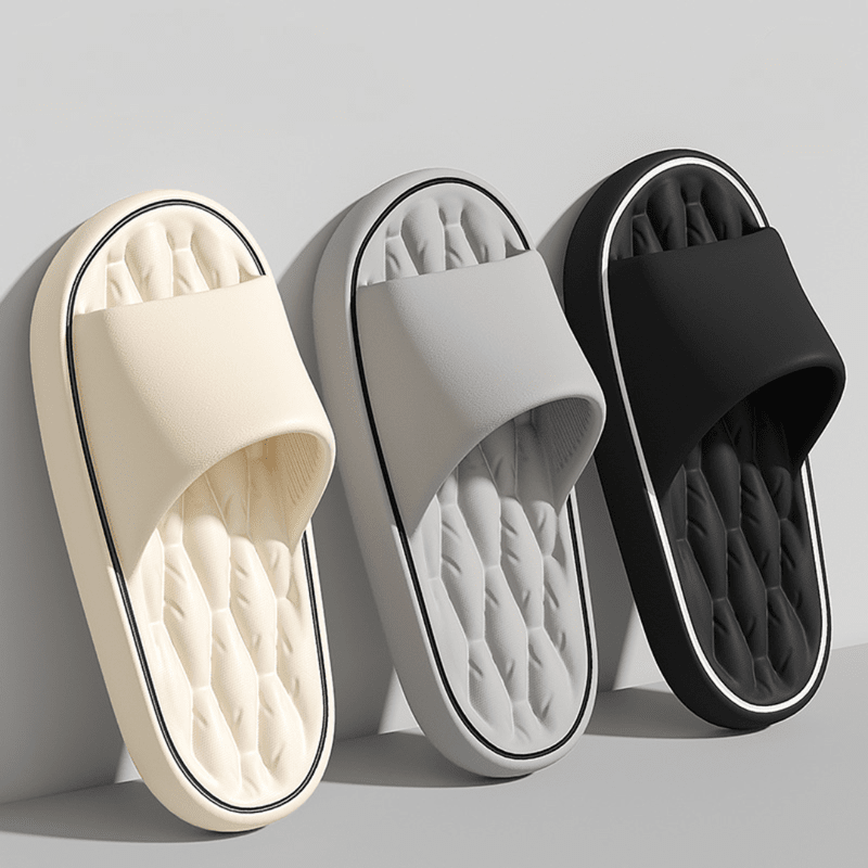 Three pairs of slippers in beige, gray, and black on a light gray background