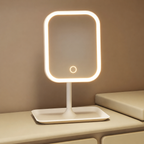 Rectangular vanity mirror with LED lighting on a beige surface.