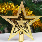 Gold star-shaped Christmas tree topper with a blurred festive background