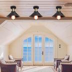 Living room with arched window and three ceiling lights.