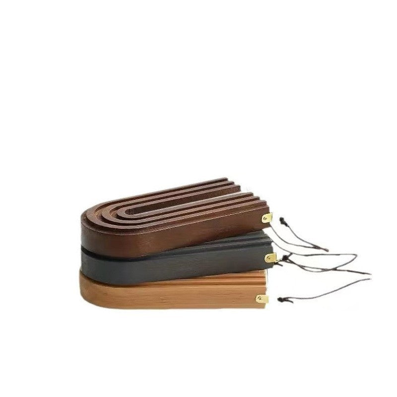 Set of wooden belts with a wooden holder on a white background