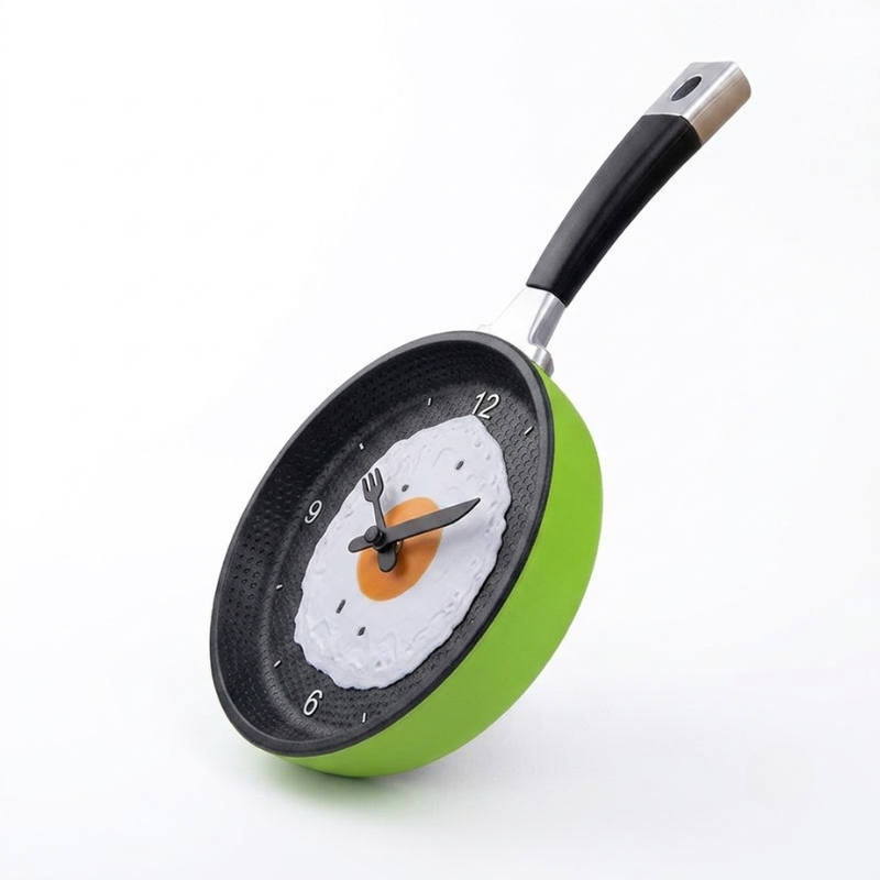 Frying pan clock with a design of an egg and fork on a white background