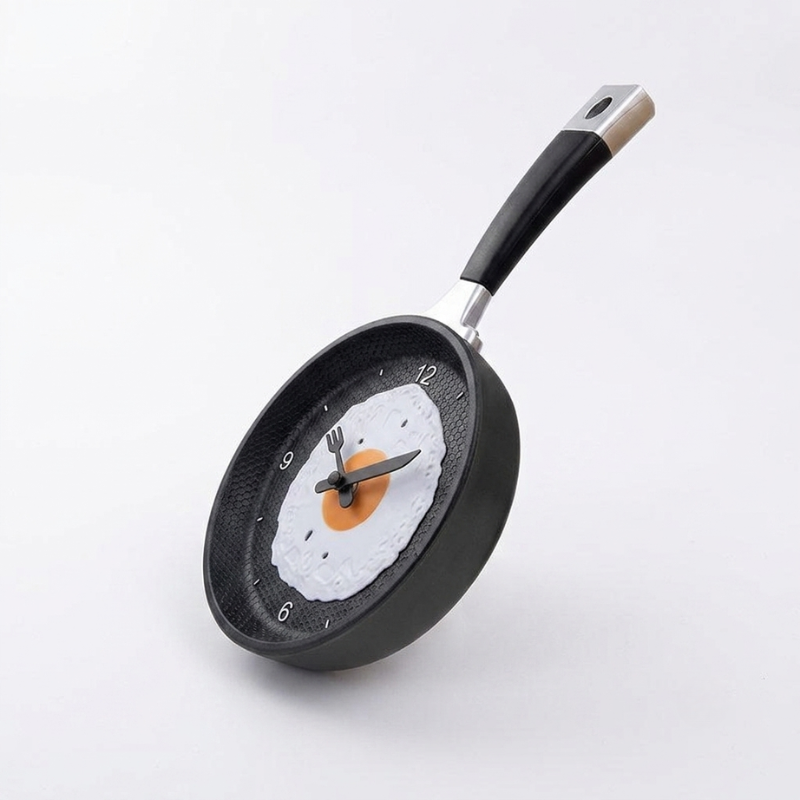 Frying pan clock with a snowman design on a white background