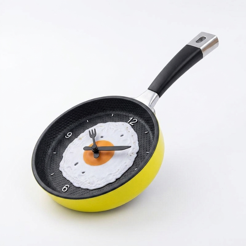 Frypan clock with a fried egg design on a white background