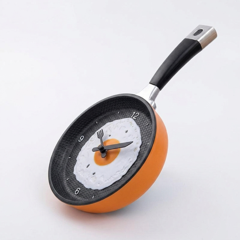 Frying pan clock with a pancake design on a white background