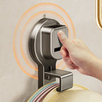 Hand pressing a modern soap dispenser on a bathroom wall.
