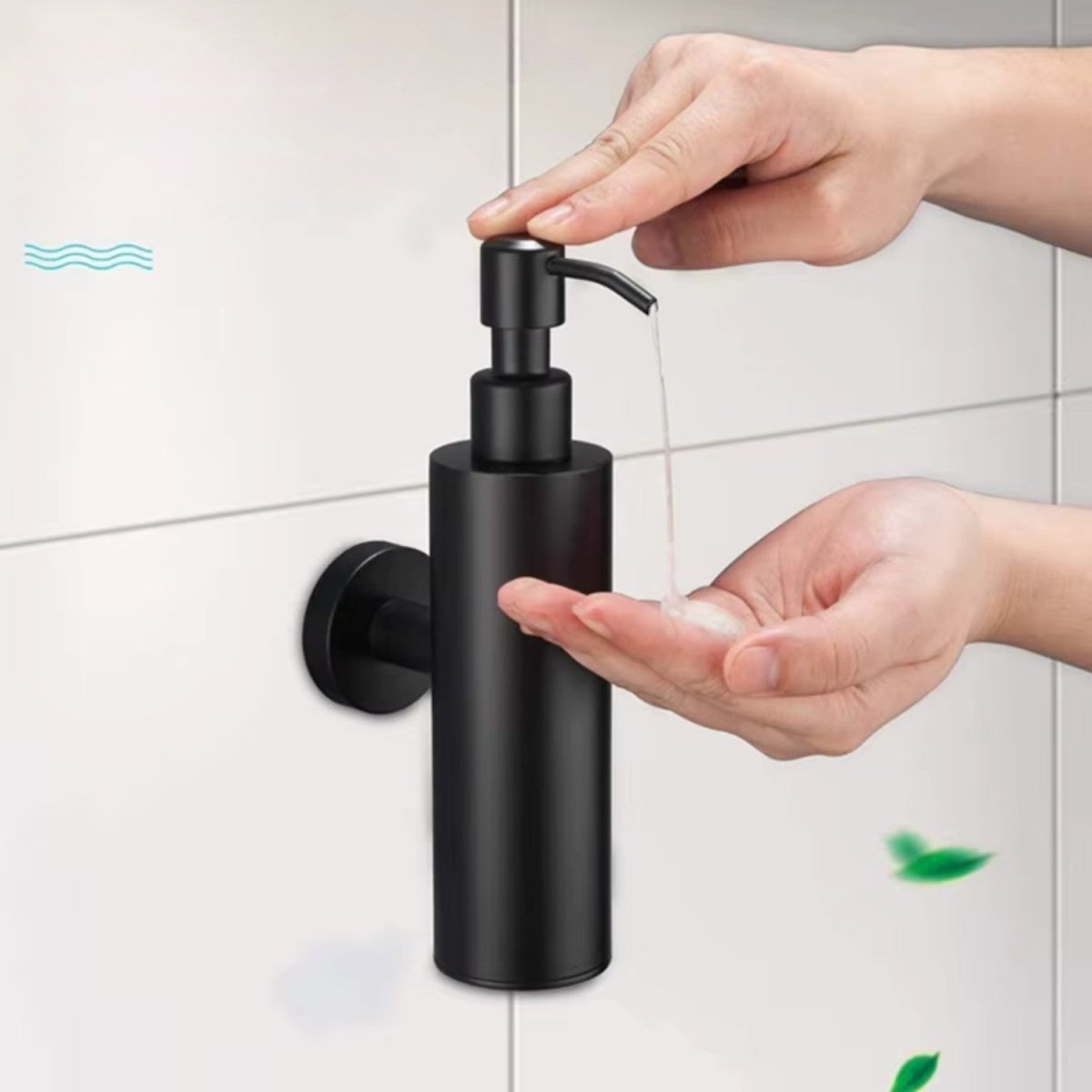 A matte black wall-mounted pump dispenser being used by two hands to dispense soap onto a palm, set against a light gray tiled wall.