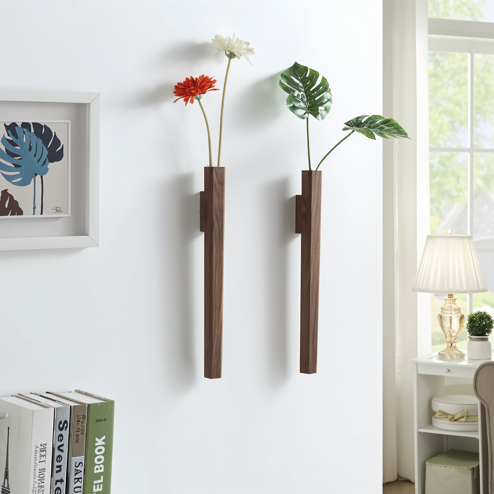 Two wall-mounted vases with plants and flowers in a home setting.