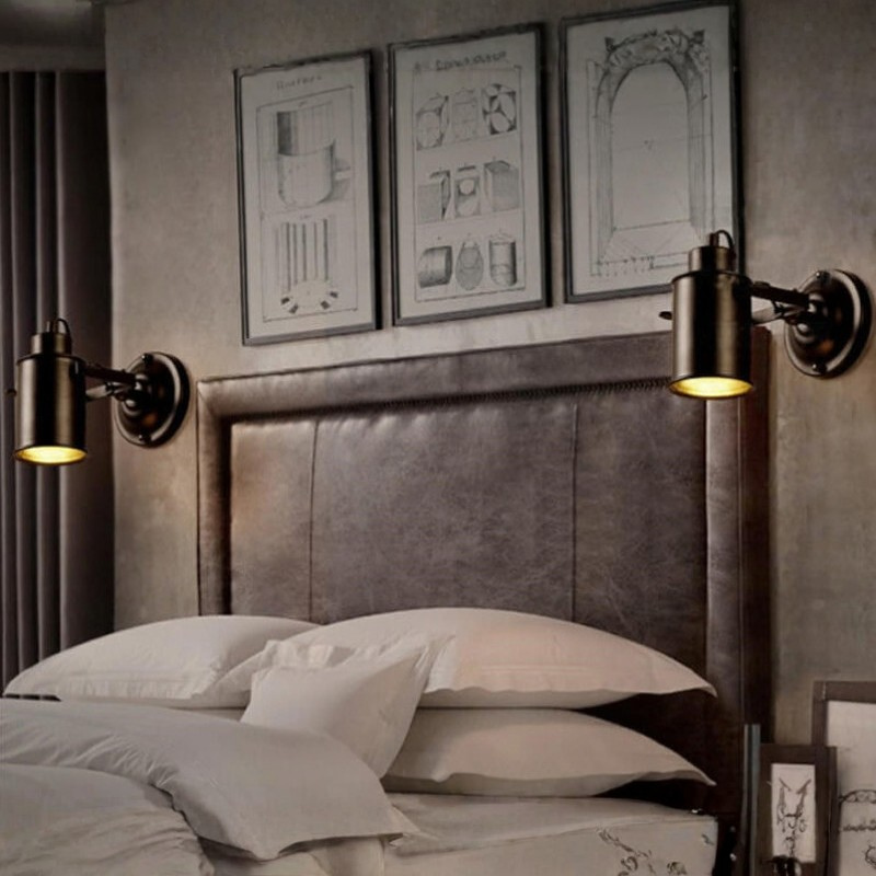 Bedroom with leather headboard, wall sconces, and framed art on the wall.