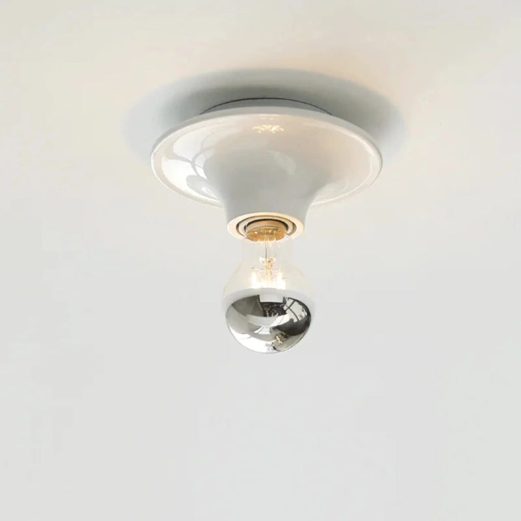 Ceiling light fixture with a glass shade on a white background