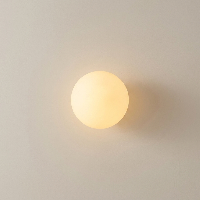Round wall light fixture on a plain wall