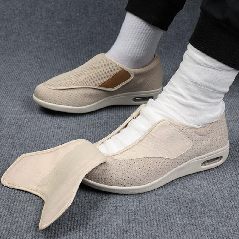 Beige slip-on shoes with a fish tail design worn by a person on a gray carpet.