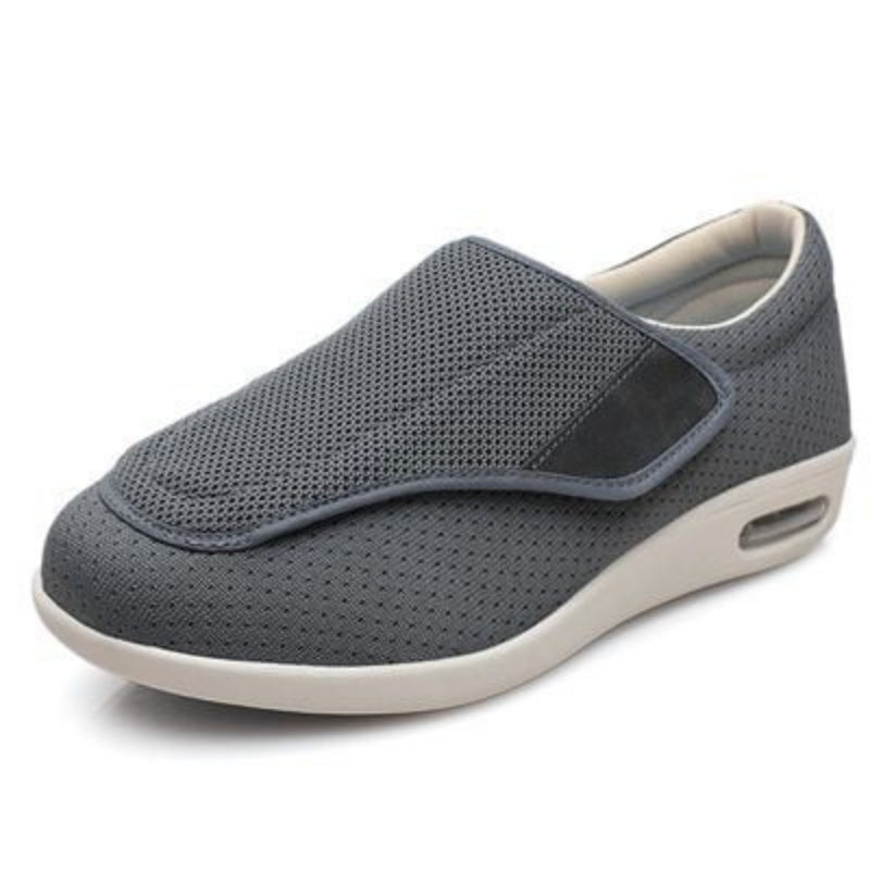 Gray slip-on shoe with white sole on a white background