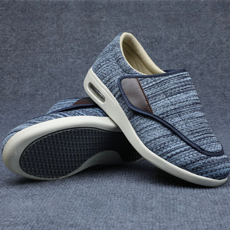 Blue slip-on shoes with white soles on a gray background