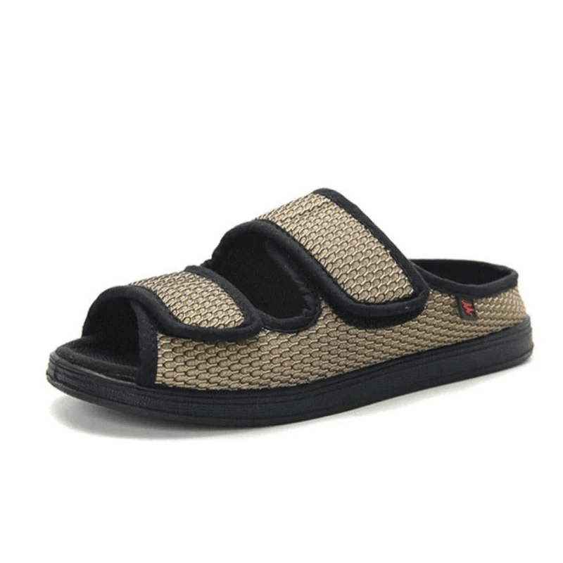 Beige and black sandal with velcro straps on a white background
