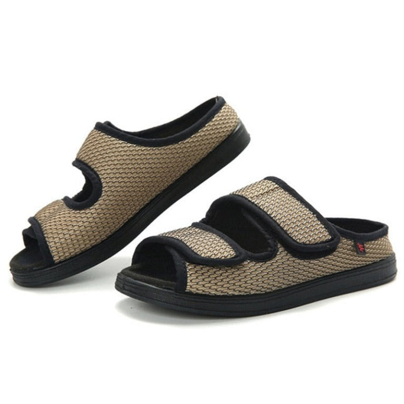 Pair of beige and black slippers on a white background