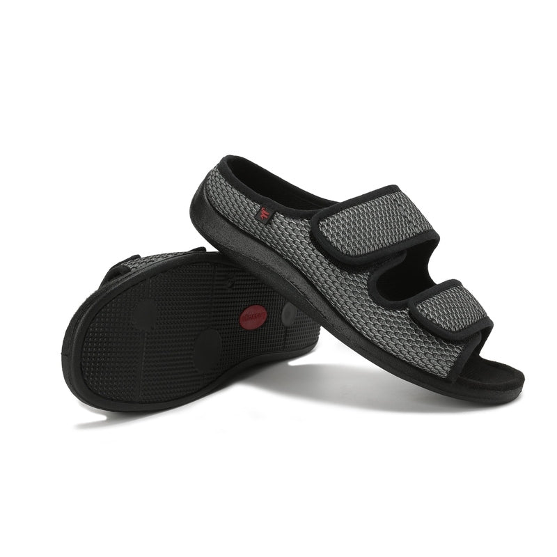 Black and gray sandals with velcro straps on a white background