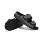 Black and gray sandals with velcro straps on a white background