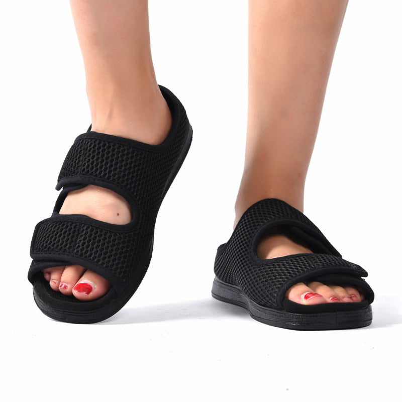 Black sandals worn on feet with a white background