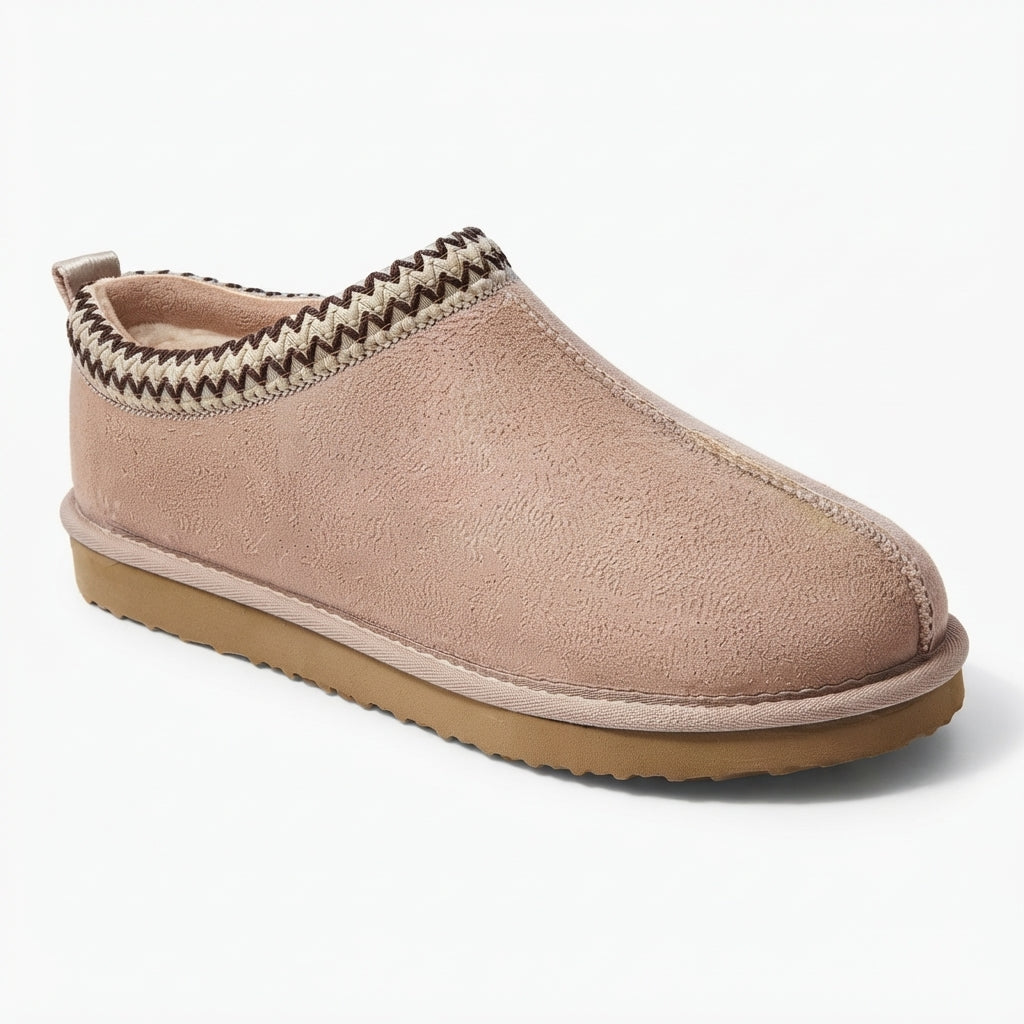 A single slip-on clog-style shoe in dusty blush pink faux suede, featuring a brown and beige chevron patterned trim around the collar and a tan rubber sole, shown on a white background.