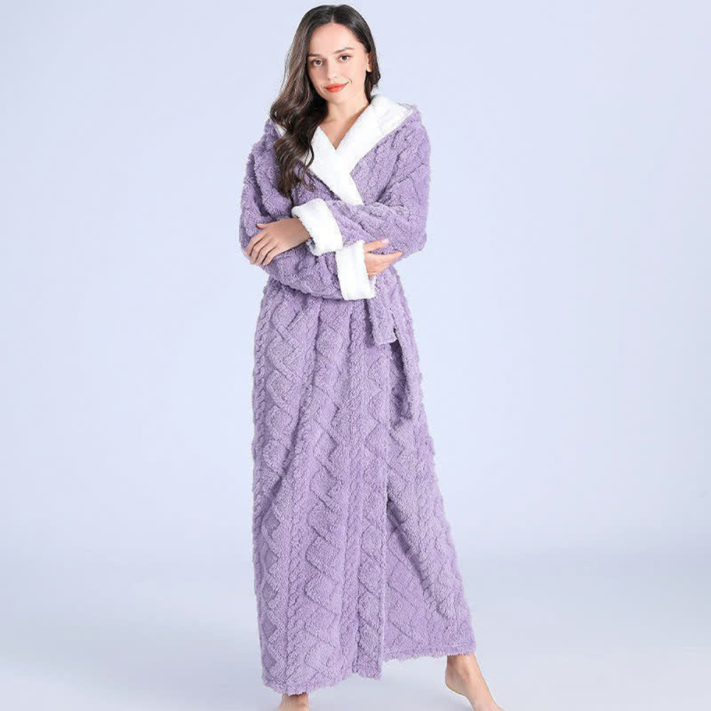 Woman wearing a purple cable knit robe on a light purple background