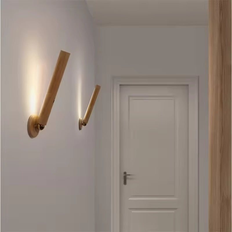 Modern wall sconces on a white wall with a door in the background