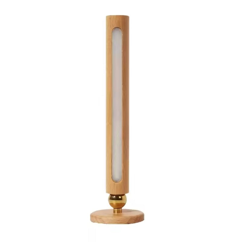 Tall cylindrical lamp with wooden base and gold accent on a white background