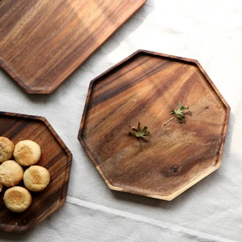 Wooden trays of different shapes on a light gray surface