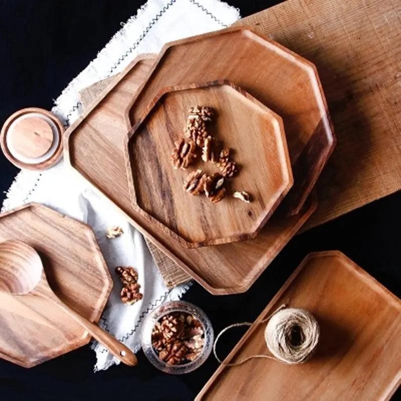 Wooden trays with walnuts on a dark surface