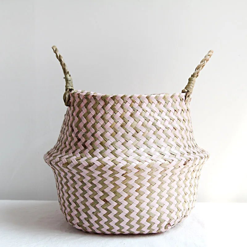 Woven basket with pink and beige pattern on a white background