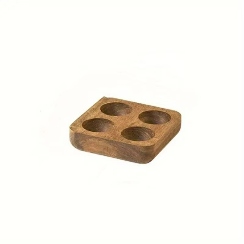 Wooden four-hole coaster on a white background