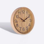 Wooden wall clock with black numbers on a white background