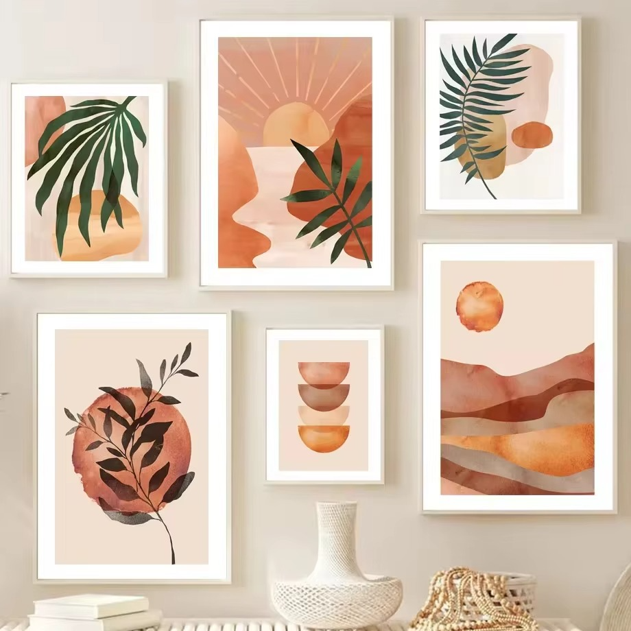 Set of six framed prints with abstract designs and leaf elements on a wall.