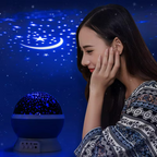 Woman looking at a starry night light projection device