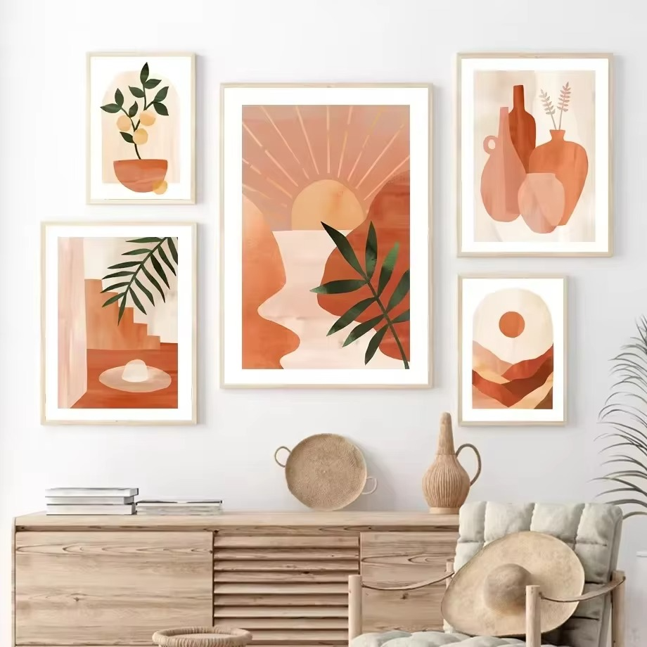 Wall with framed abstract art in warm colors, wooden console table, and decorative items.