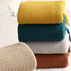 Stack of colorful knitted blankets