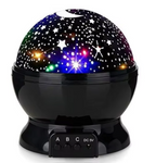 Colorful starry night light projector on a white background