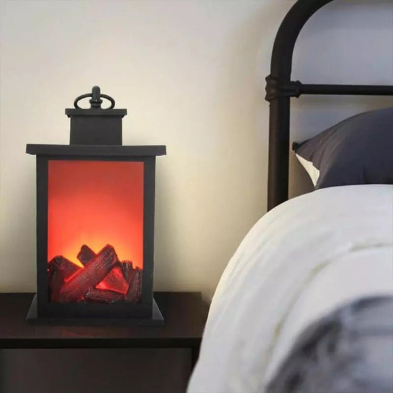 Black lantern with glowing red interior on a nightstand next to a bed.