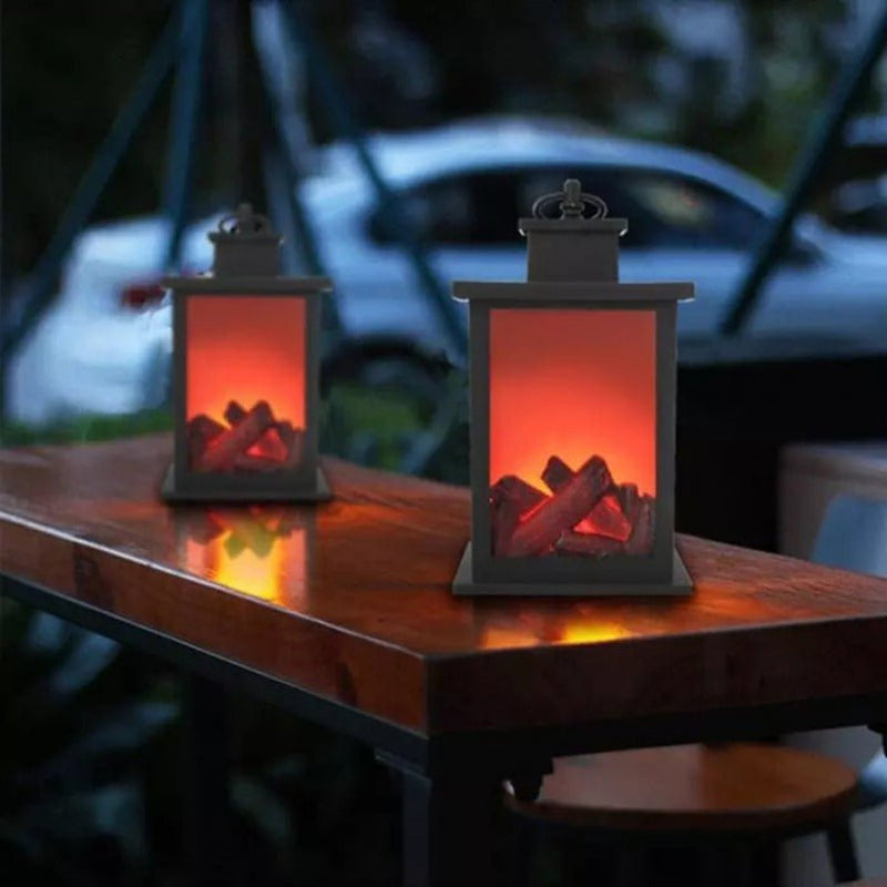Two decorative lanterns with glowing red interior on a wooden surface.