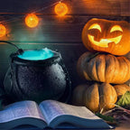 Halloween-themed scene with a cauldron, pumpkins, and an open book on a wooden background.