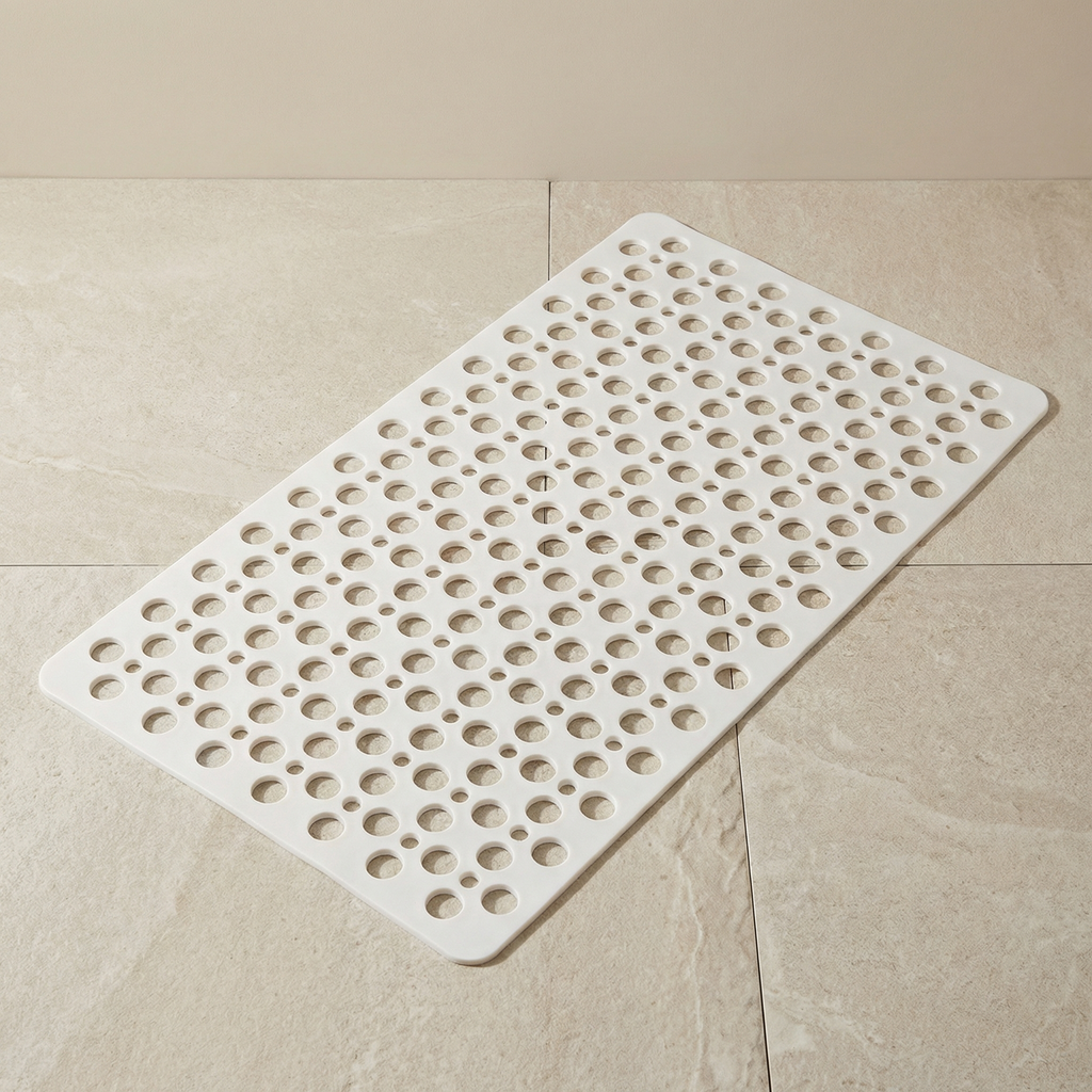 White textured bath mat on a beige tiled floor