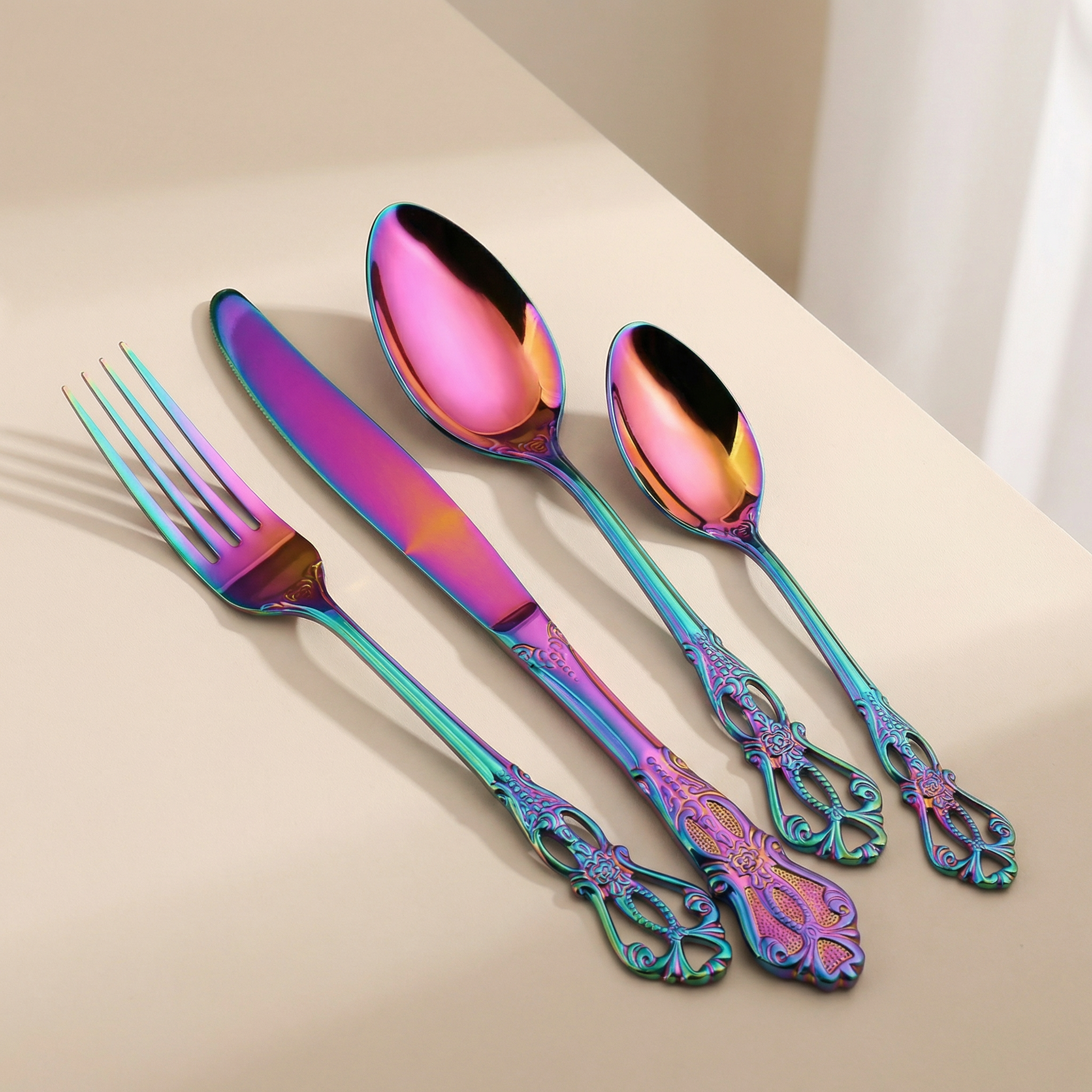 Set of colorful cutlery on a beige surface