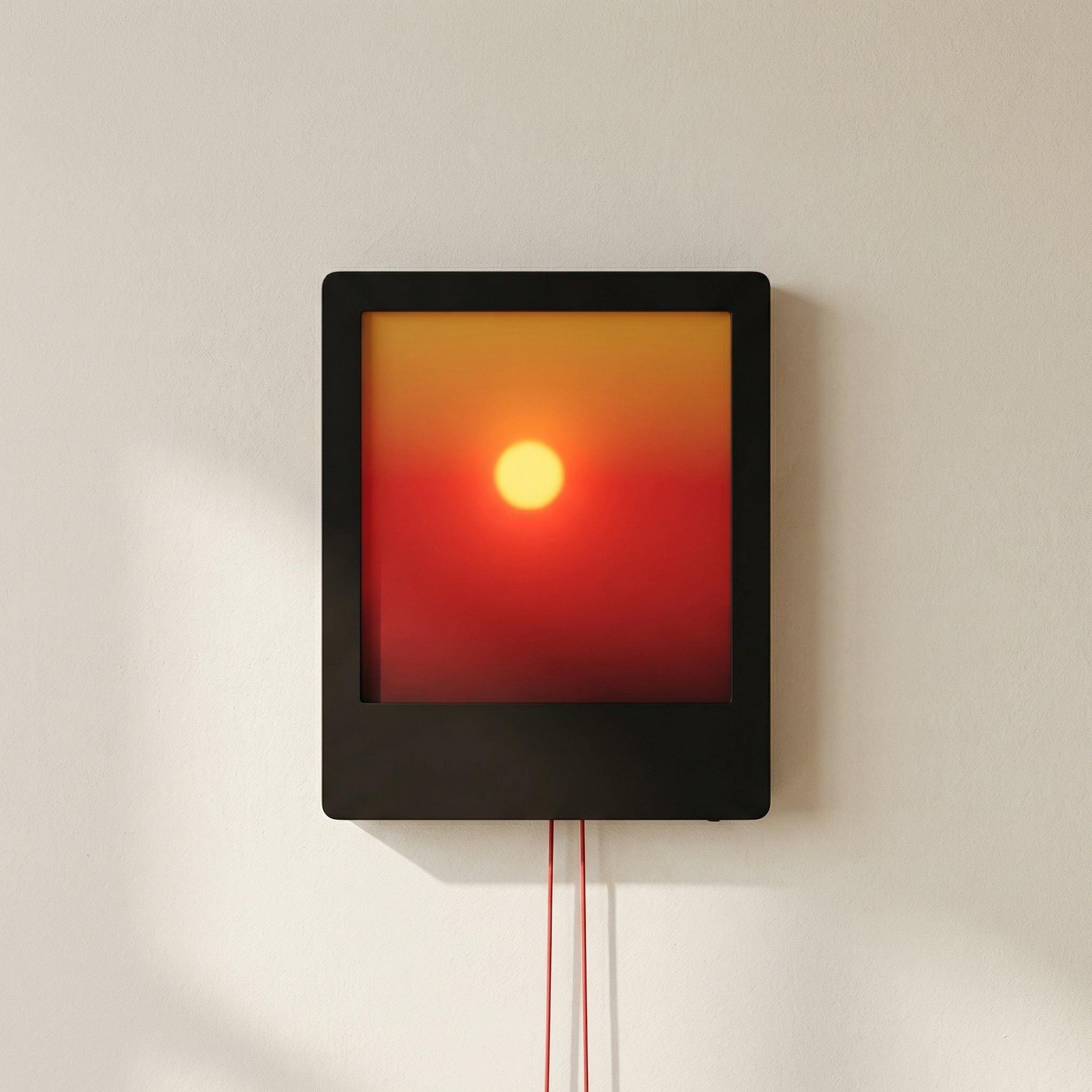 Square wall light with a gradient from red to yellow on a white wall