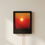 Square wall light with a gradient from red to yellow on a white wall