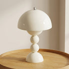 White table lamp with a unique design on a wooden surface
