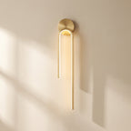 Gold wall sconce on a beige wall