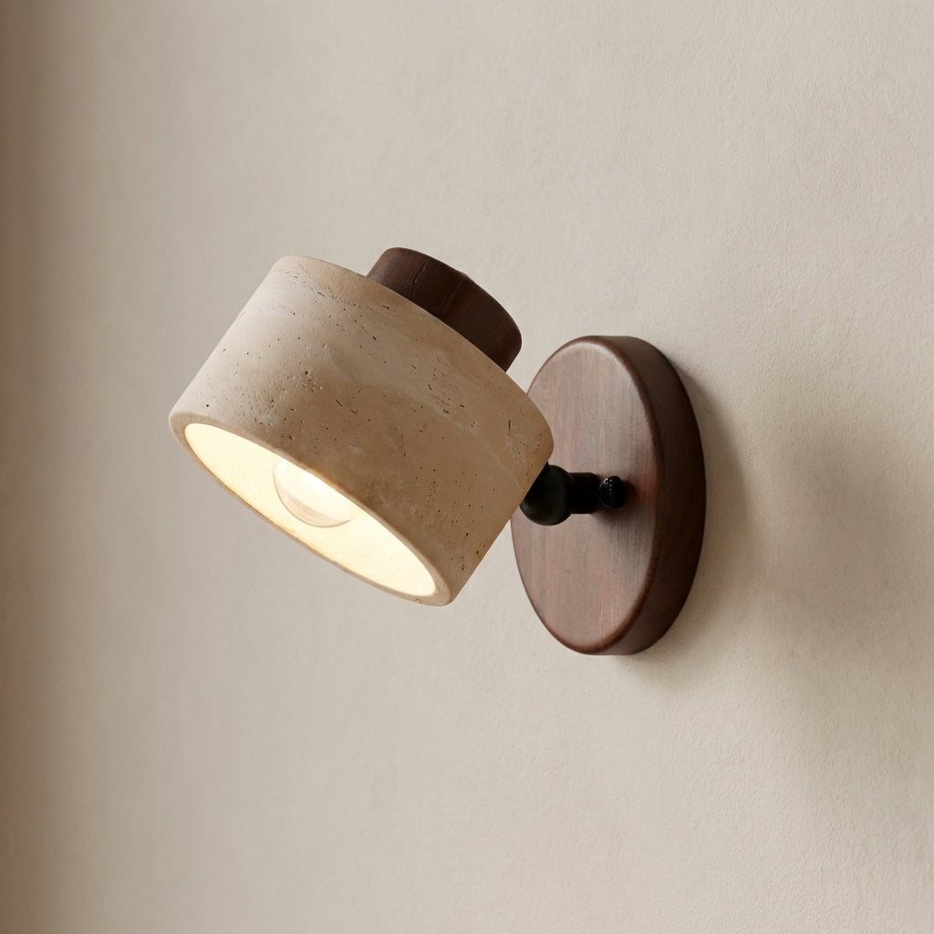 Wall-mounted light fixture with beige shade and wooden base on a neutral wall.