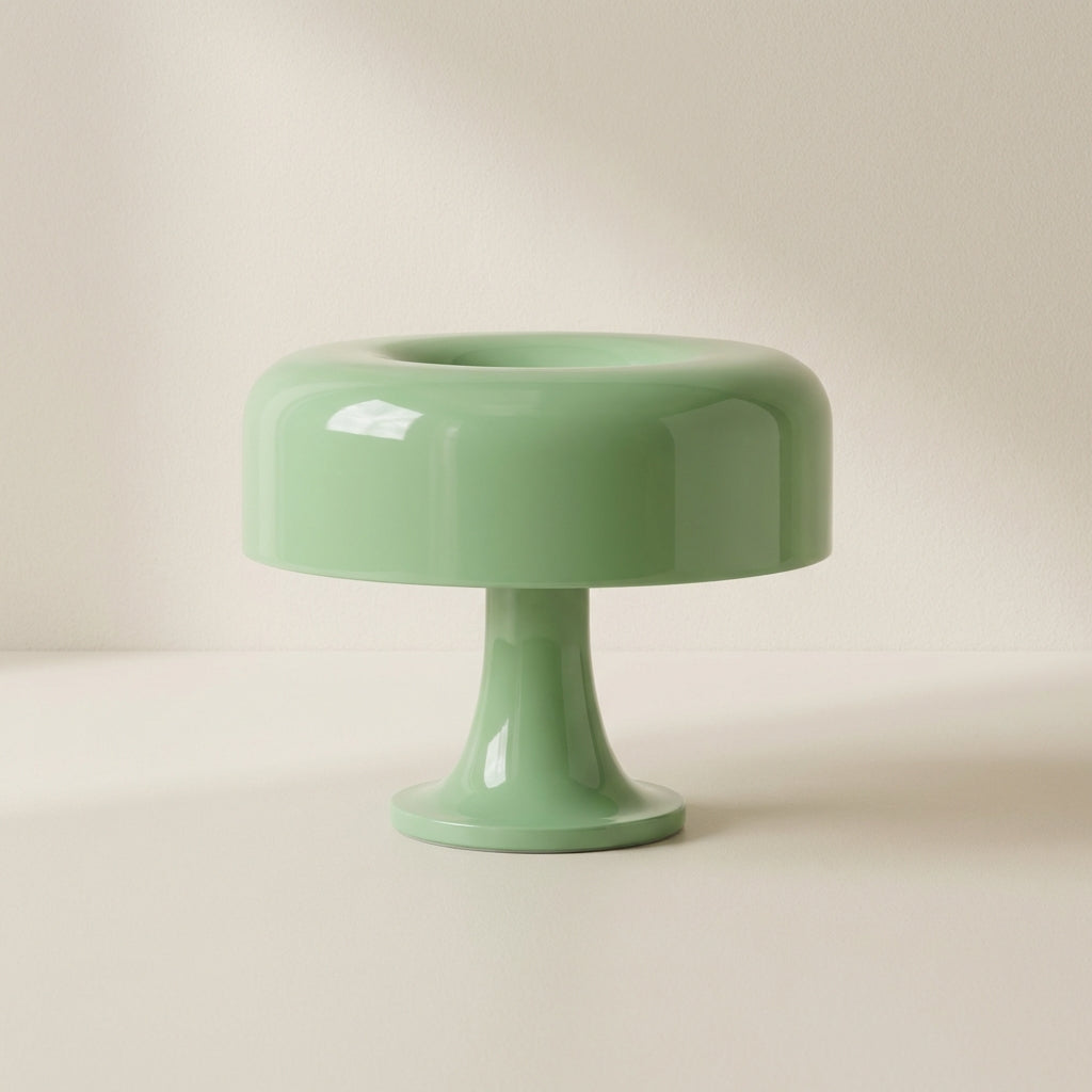 Green ceramic cake stand on a beige background