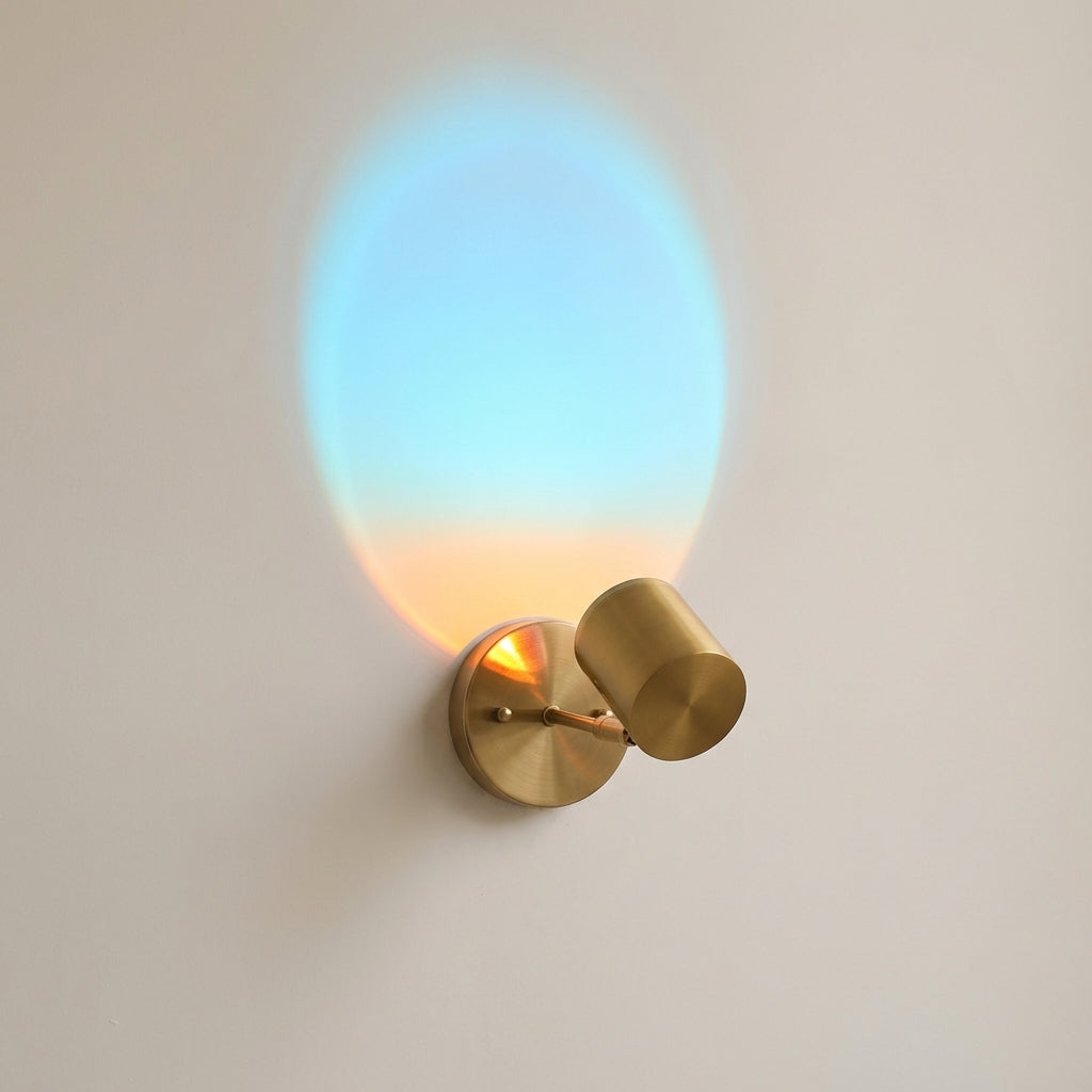 Wall-mounted light fixture with a gradient glass shade on a plain wall.