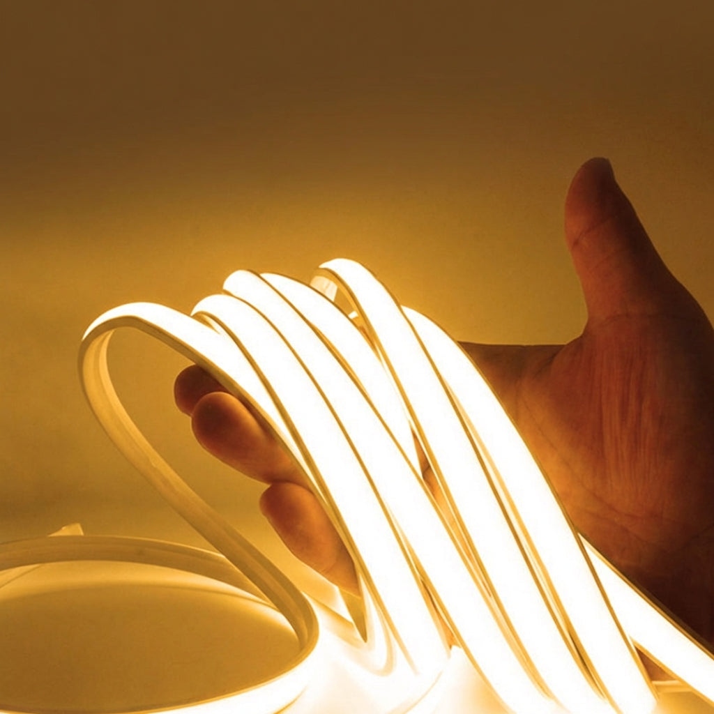 Neon light strip held by a hand against a yellow background